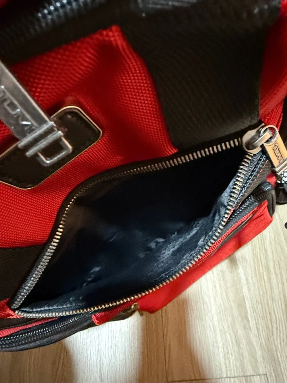 Tumi Red and Black Men/Women’s Backpack with Multiple Front Pockets